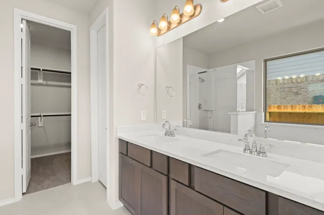 a bathroom with a double vanity sink mirror and double