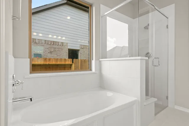 a white bath tub sitting next to a window