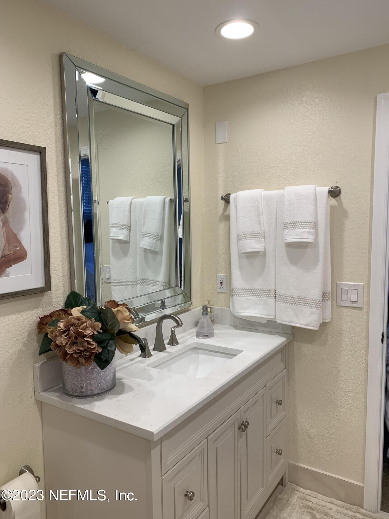 8550 Touchton Road, Unit 1018 Jacksonville, FL 32216 - Photo 5 of 15 a bathroom with a sink and a mirror