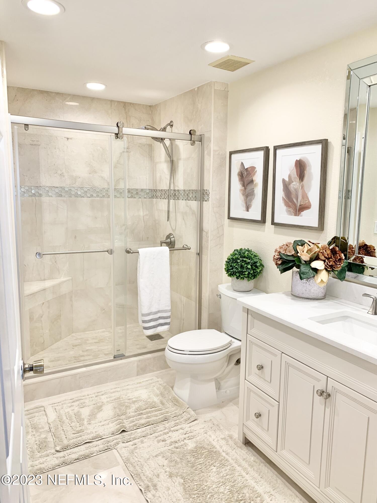 8550 Touchton Road, Unit 1018 Jacksonville, FL 32216 - Photo 6 of 15 a bathroom with a sink toilet and shower