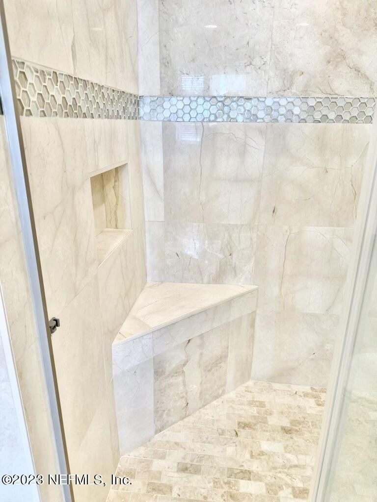 8550 Touchton Road, Unit 1018 Jacksonville, FL 32216 - Photo 7 of 15 a bathroom with a tub shower and a sink