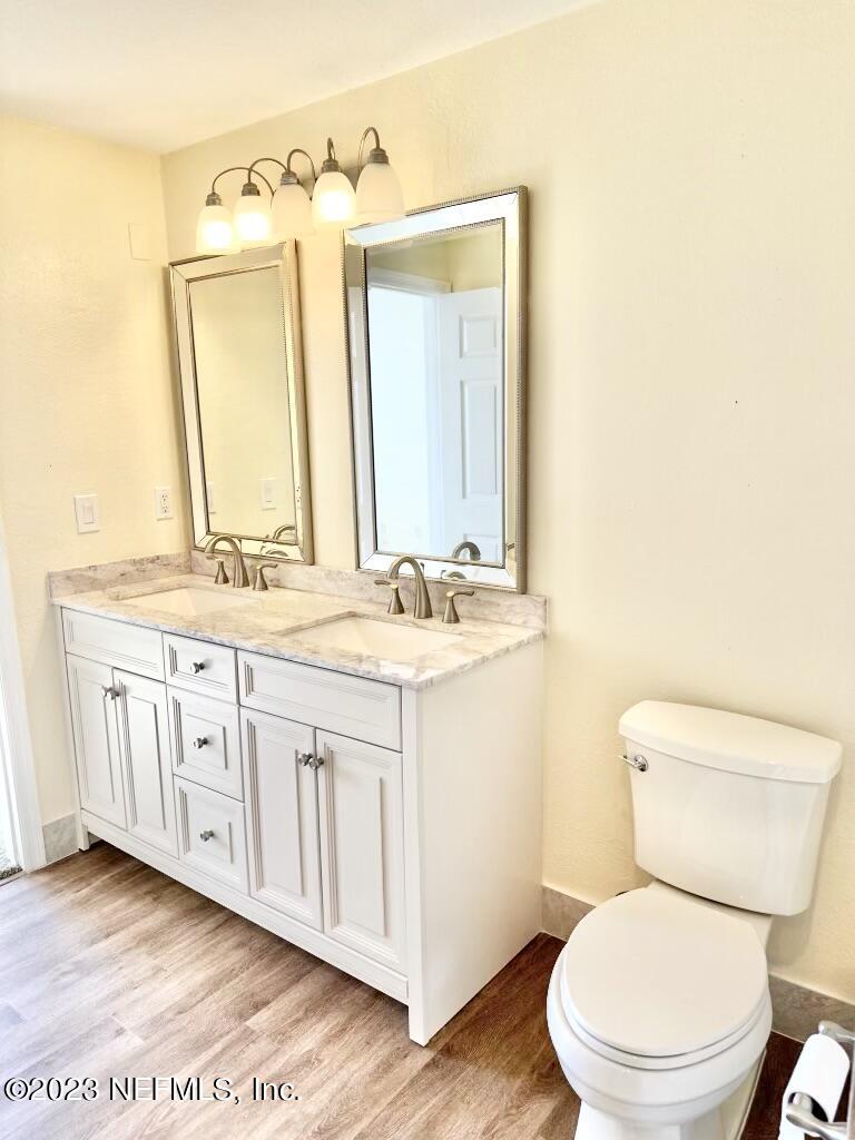 8550 Touchton Road, Unit 1018 Jacksonville, FL 32216 - Photo 8 of 15 a bathroom with a granite countertop toilet sink and mirror