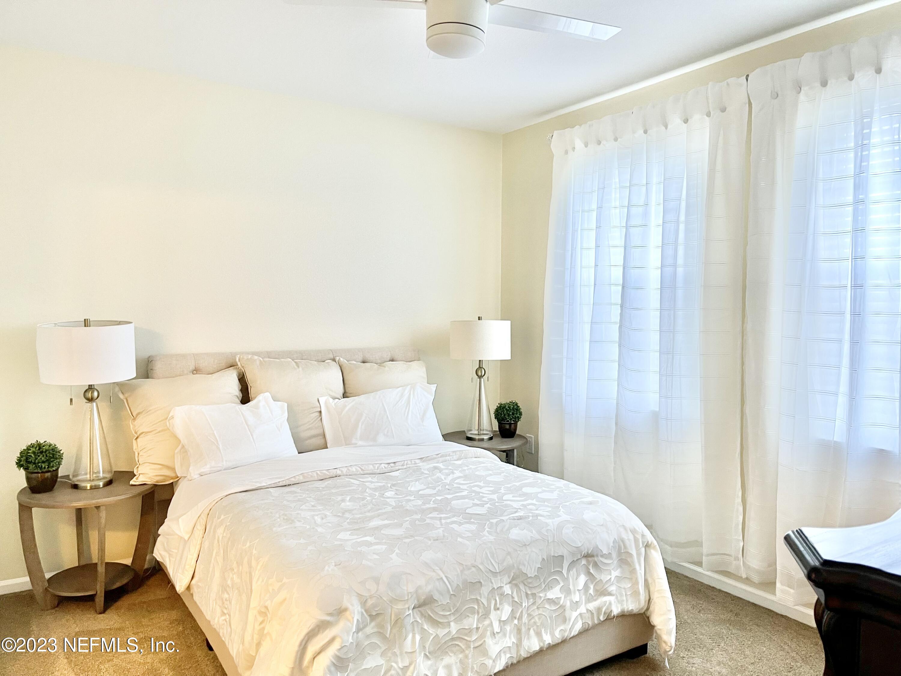 8550 Touchton Road, Unit 1018 Jacksonville, FL 32216 - Photo 10 of 15 a bedroom with a bed and a night stand