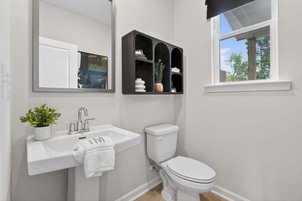 747 Meadow Ridge Lane Cumming, GA 30040 - Photo 26 of 41 a bathroom with a toilet sink and mirror