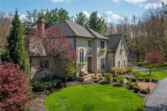 a front view of house with a garden