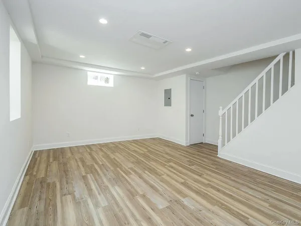 a view of empty room with wooden floor