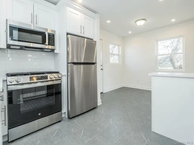 a kitchen with a refrigerator stove and microwave