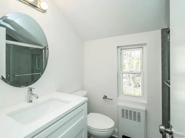 a bathroom with a sink toilet and mirror