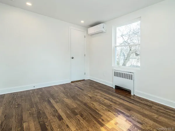 a view of a room with wooden floor and windows
