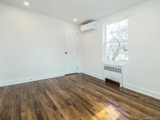 a view of a room with wooden floor and windows