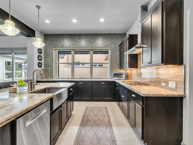 a kitchen with stainless steel appliances granite countertop wooden counter tops and a granite counter tops