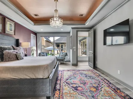 a bedroom with a large bed and a flat screen tv