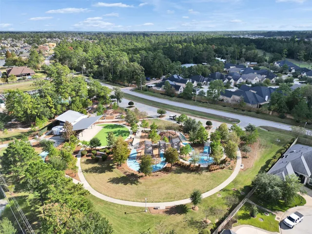 an aerial view of multiple houses with a yard
