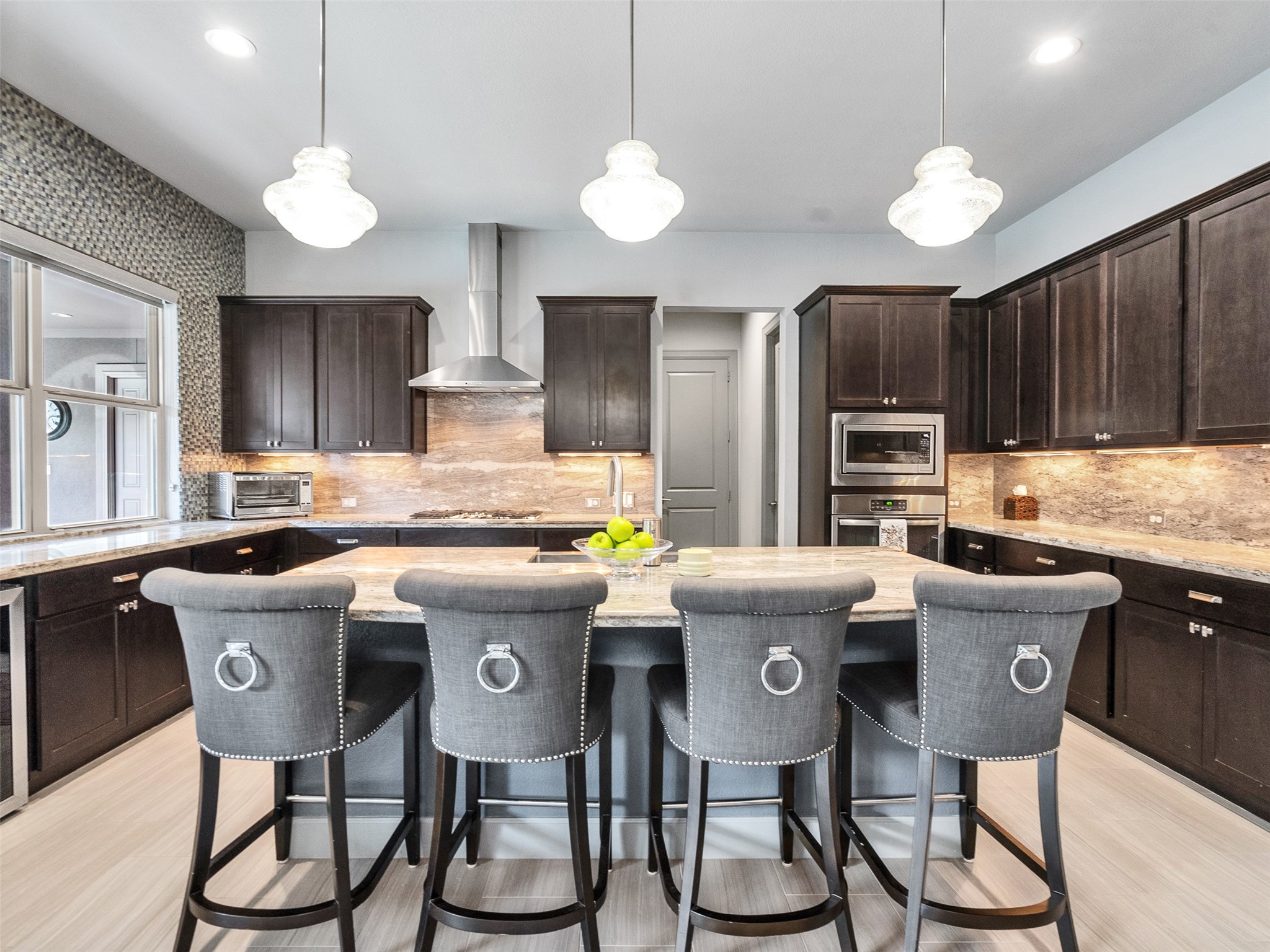 7415 Nantucket Point Lane Spring, TX 77389 - Photo 10 of 49 a kitchen with stainless steel appliances granite countertop a stove a refrigerator a sink a dining table and chairs with wooden floor