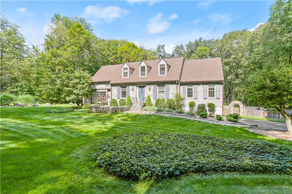 84 Thunder Lake Road Wilton, CT 06897 - Photo 1 of 1 a view of a house with a yard table and chairs