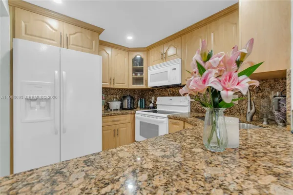 a kitchen with a refrigerator and a sink