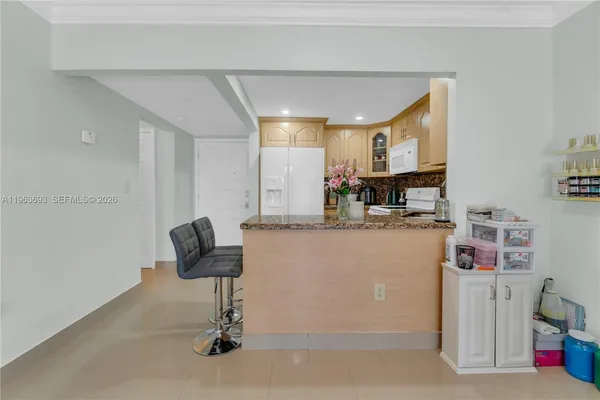 a view of a dining room with furniture and a chandelier