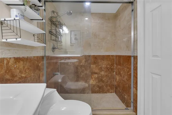 a bathroom with a shower and a toilet
