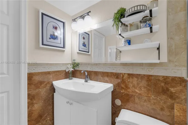 a bathroom with a sink a mirror and a toilet