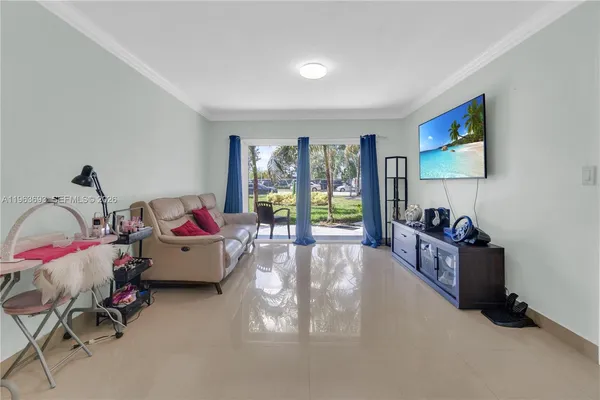 a living room with furniture and a flat screen tv
