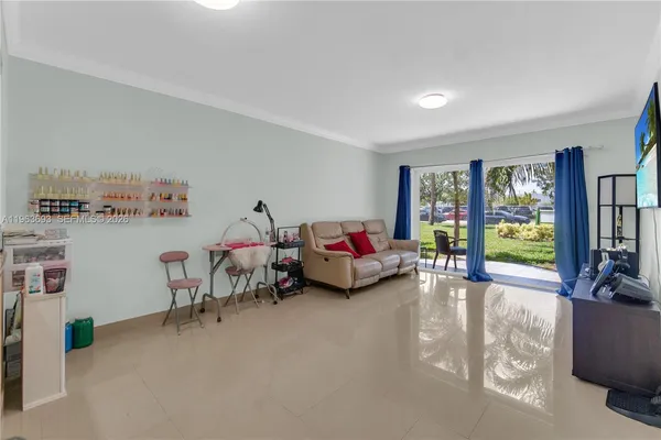 a living room with furniture and kitchen view