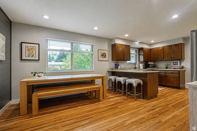 2924 Robidoux Road Sandy, UT 84093 - Photo 23 of 68 Hardwood flooring throughout, recessed lighting, shaker-style wood cabinetry, light-toned countertops, and a window with blinds