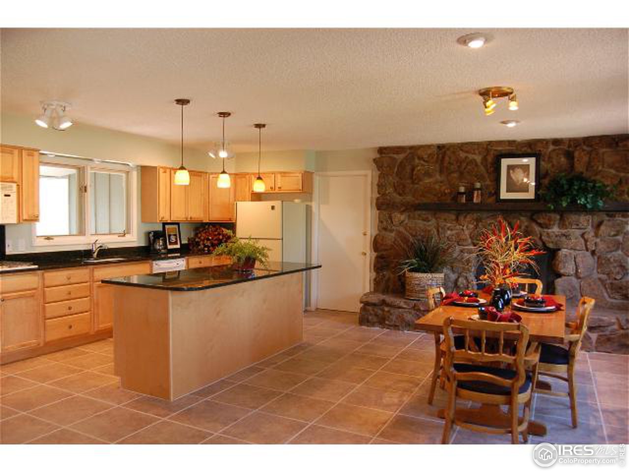7229 Olde Stage Road Boulder, CO 80302 - Photo 3 of 8 a kitchen with stainless steel appliances kitchen island granite countertop a sink and cabinets