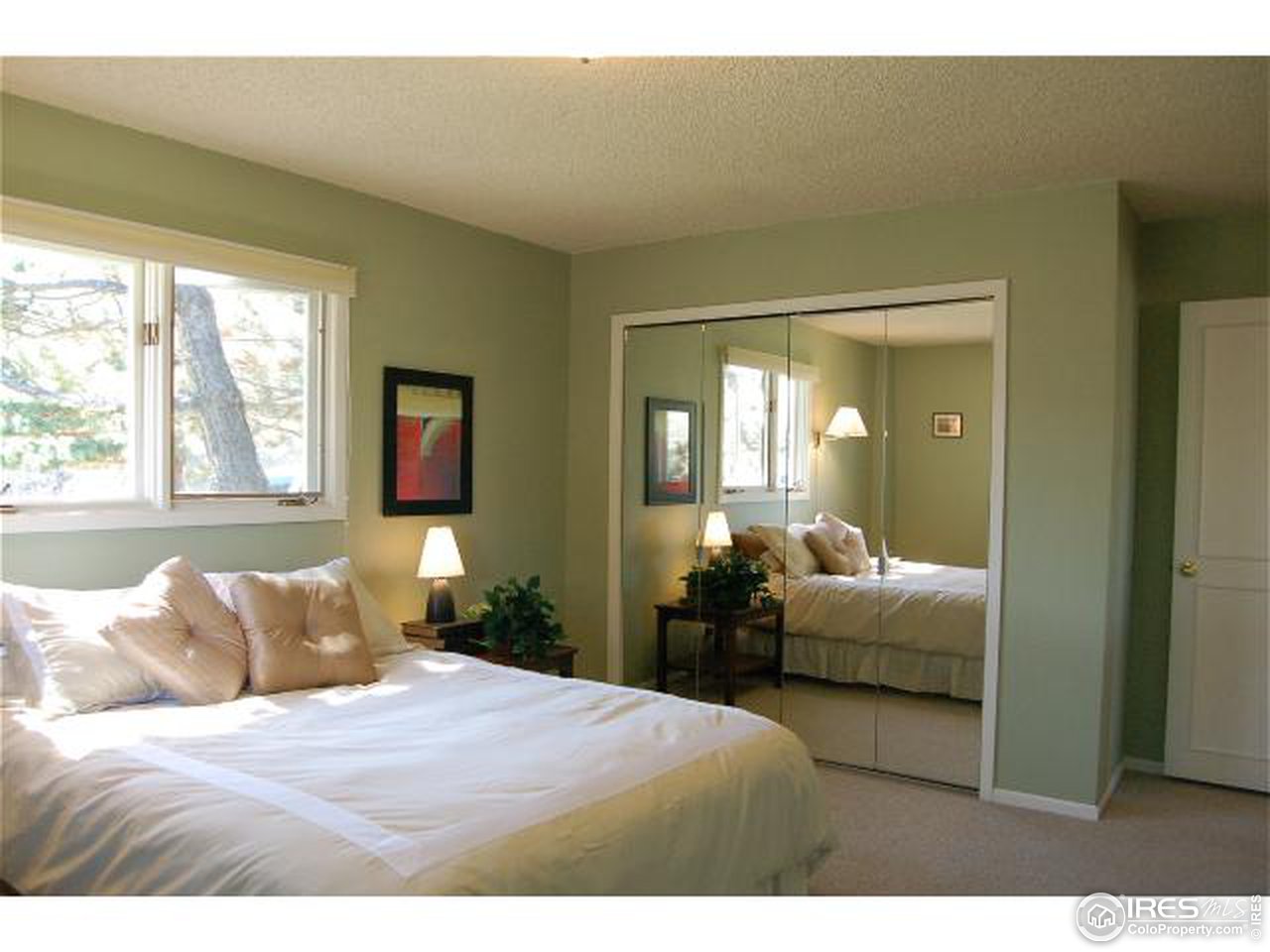 7229 Olde Stage Road Boulder, CO 80302 - Photo 4 of 8 a bedroom with a bed and a large mirror