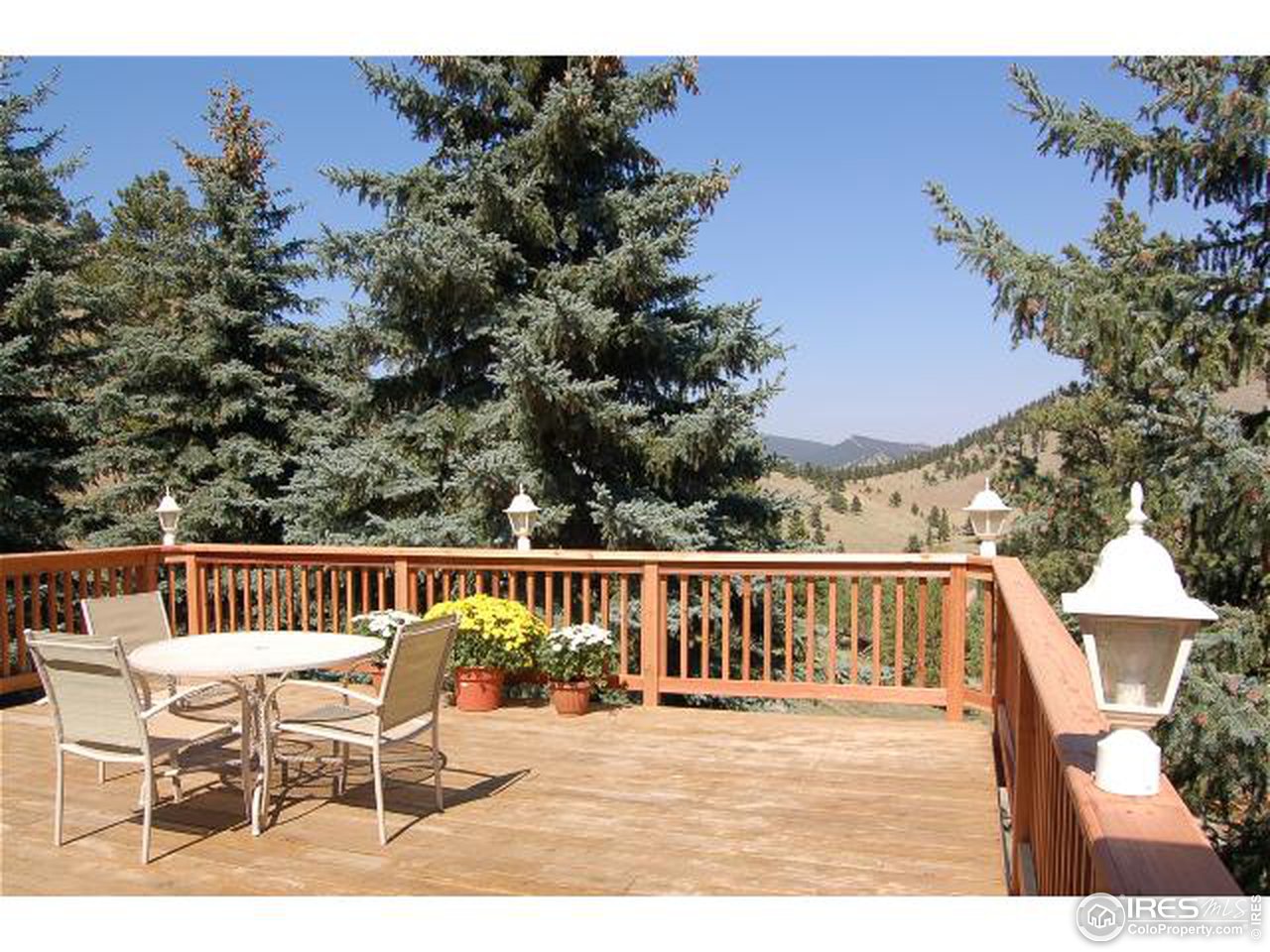 7229 Olde Stage Road Boulder, CO 80302 - Photo 6 of 8 a view of a chairs and table on the deck