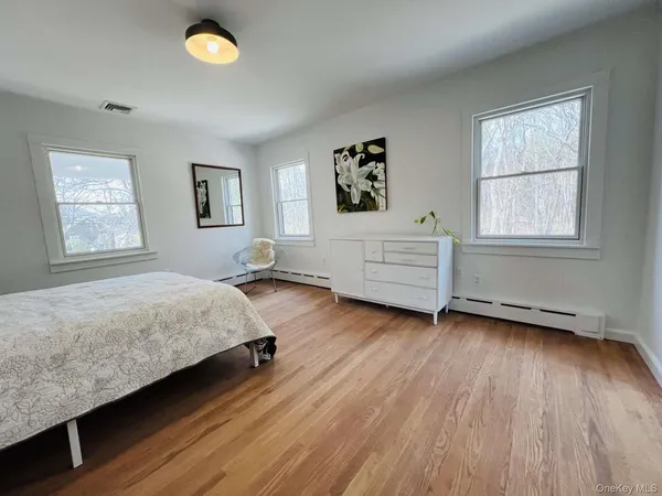 a view of a room with wooden floor and floor to ceiling window