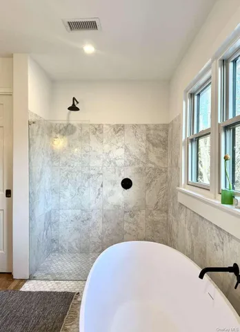 a living room with large trees and plants