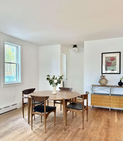 a dining room with furniture and wooden floor