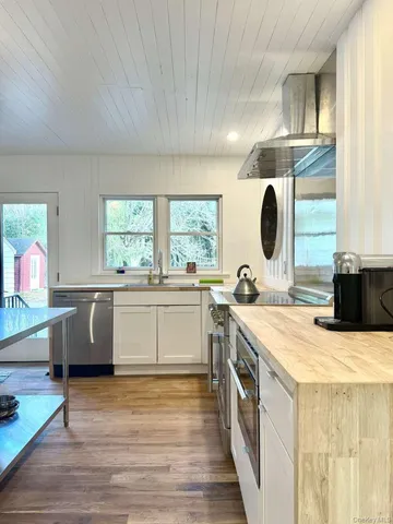 a kitchen with a stove a sink and a refrigerator