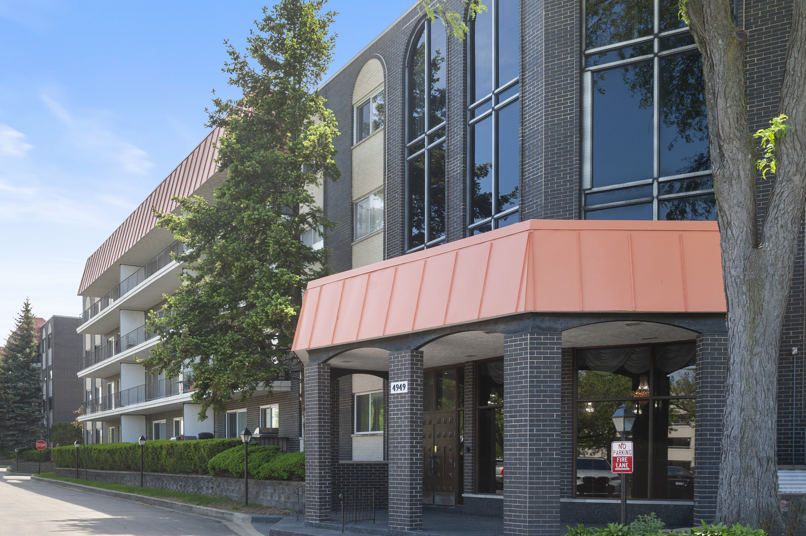 4949 Golf Road, Unit 101 Skokie, IL 60077 - Photo 1 of 22 a front view of a building with street