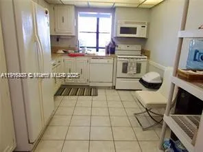 a kitchen with stainless steel appliances a stove a sink and a refrigerator