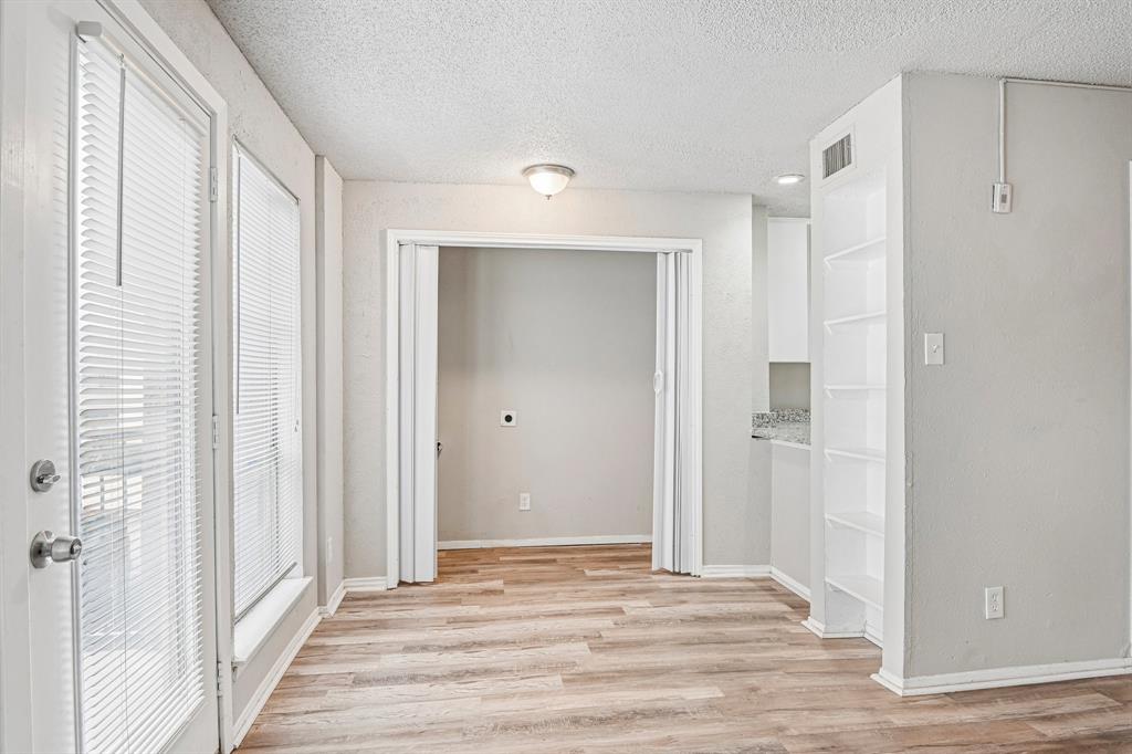 5534 Boca Raton Boulevard, Unit 292 Fort Worth, TX 76112 - Photo 11 of 31 a view of a room with wooden floor and windows