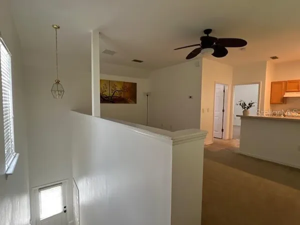 a view of a hallway with a kitchen