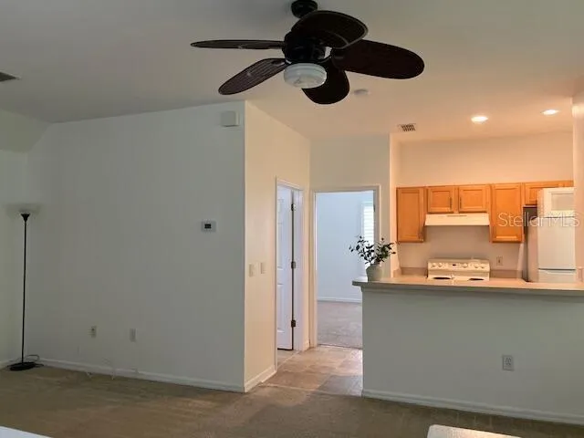 a kitchen with stainless steel appliances granite countertop cabinets and a chandelier