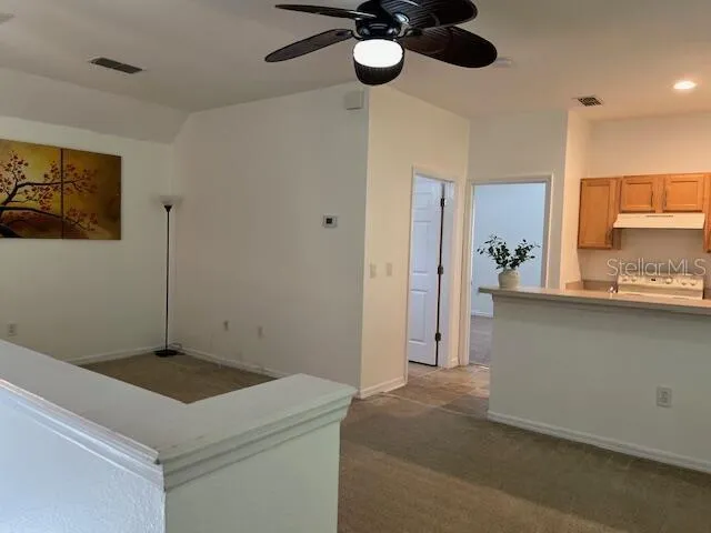 a kitchen with a refrigerator and cabinets
