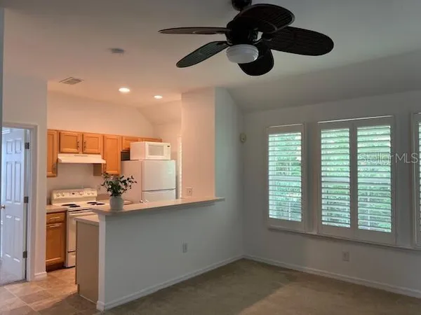 a kitchen with stainless steel appliances a sink a window and cabinets