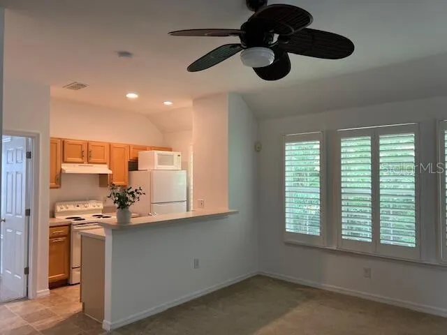 a kitchen with stainless steel appliances a sink a window and cabinets
