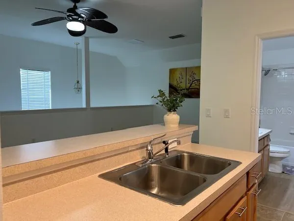 a kitchen with a sink and a toilet
