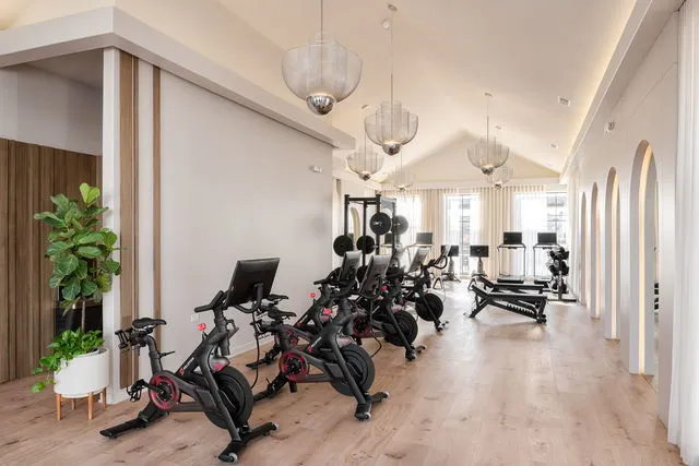 a view of a room with gym equipment and a large window