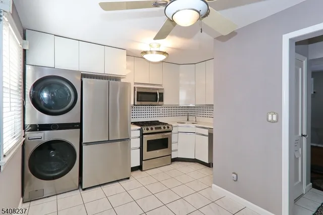 a kitchen with stainless steel appliances granite countertop a sink a stove top oven and cabinets