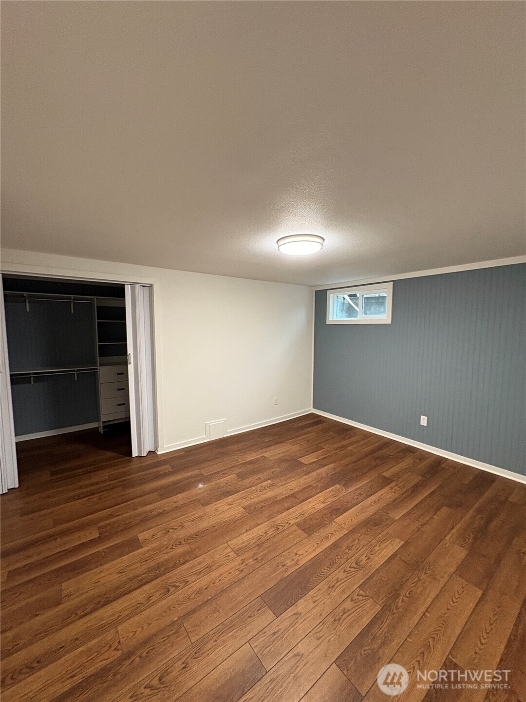 840 Northwest 54th Street Seattle, WA 98107 - Photo 17 of 18 a view of an empty room with wooden floor and closet