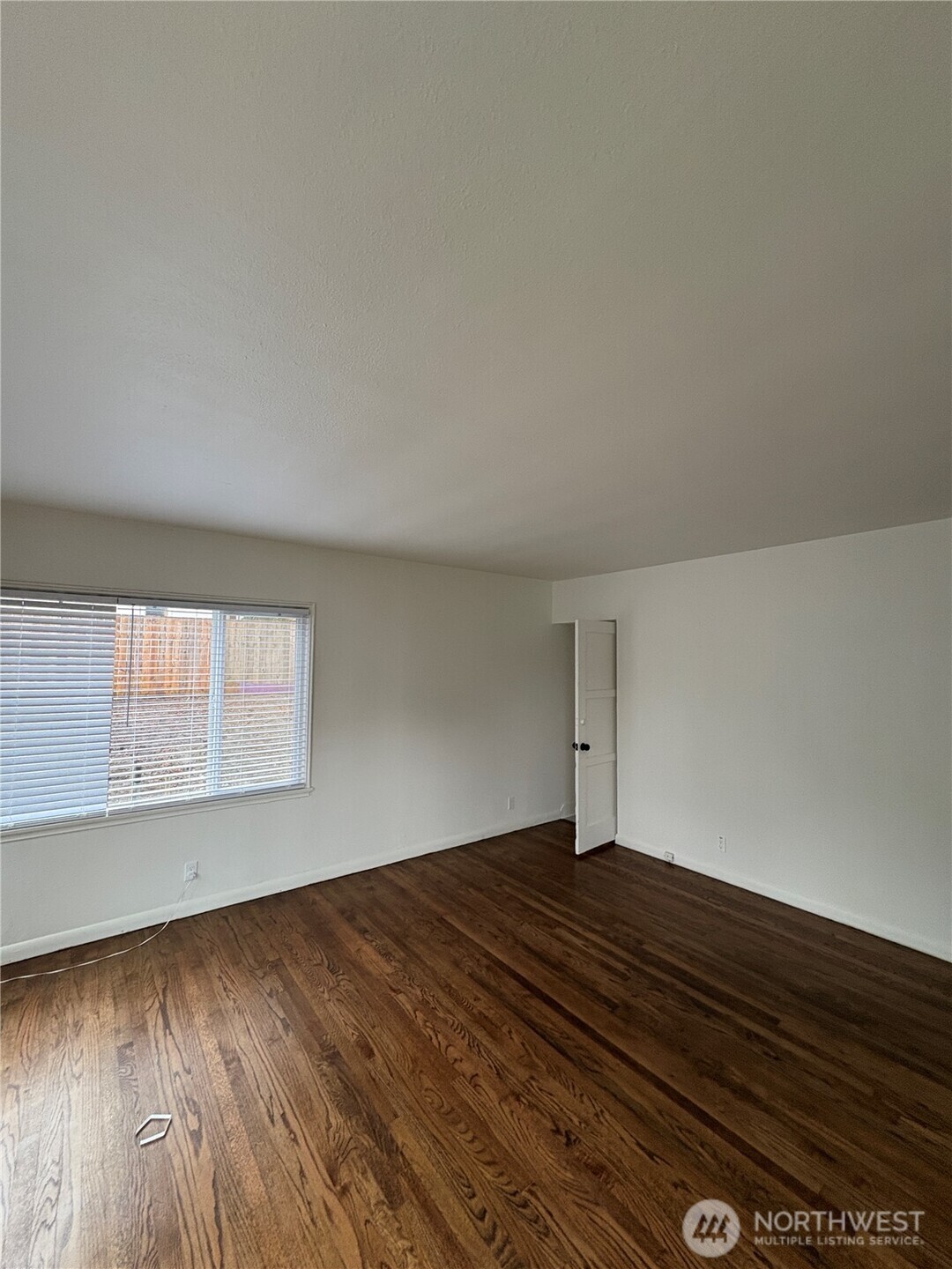 840 Northwest 54th Street Seattle, WA 98107 - Photo 3 of 18 an empty room with wooden floor and windows