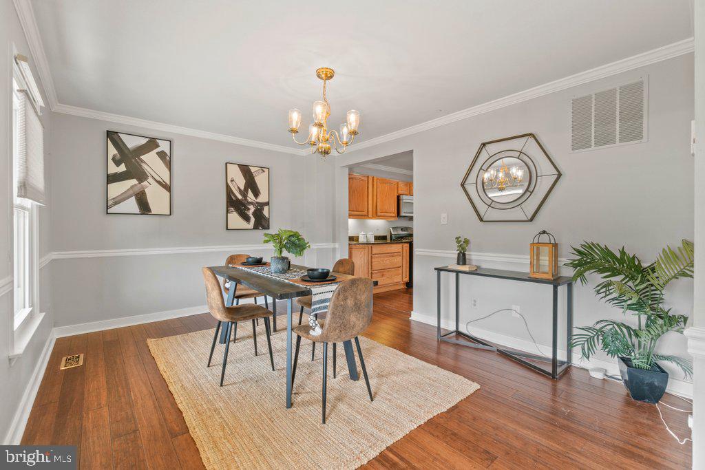 4426 Camellia Road Baltimore, MD 21236 - Photo 8 of 51 a view of a dining room with furniture wooden floor and a chandelier