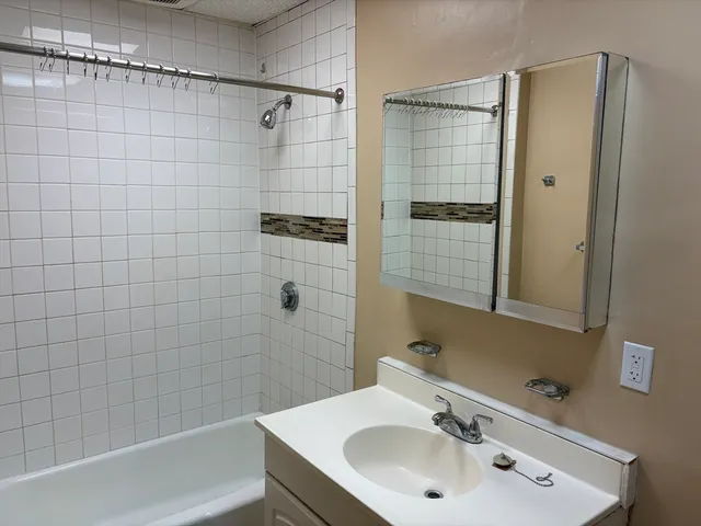 a bathroom with a sink shower and a bathtub