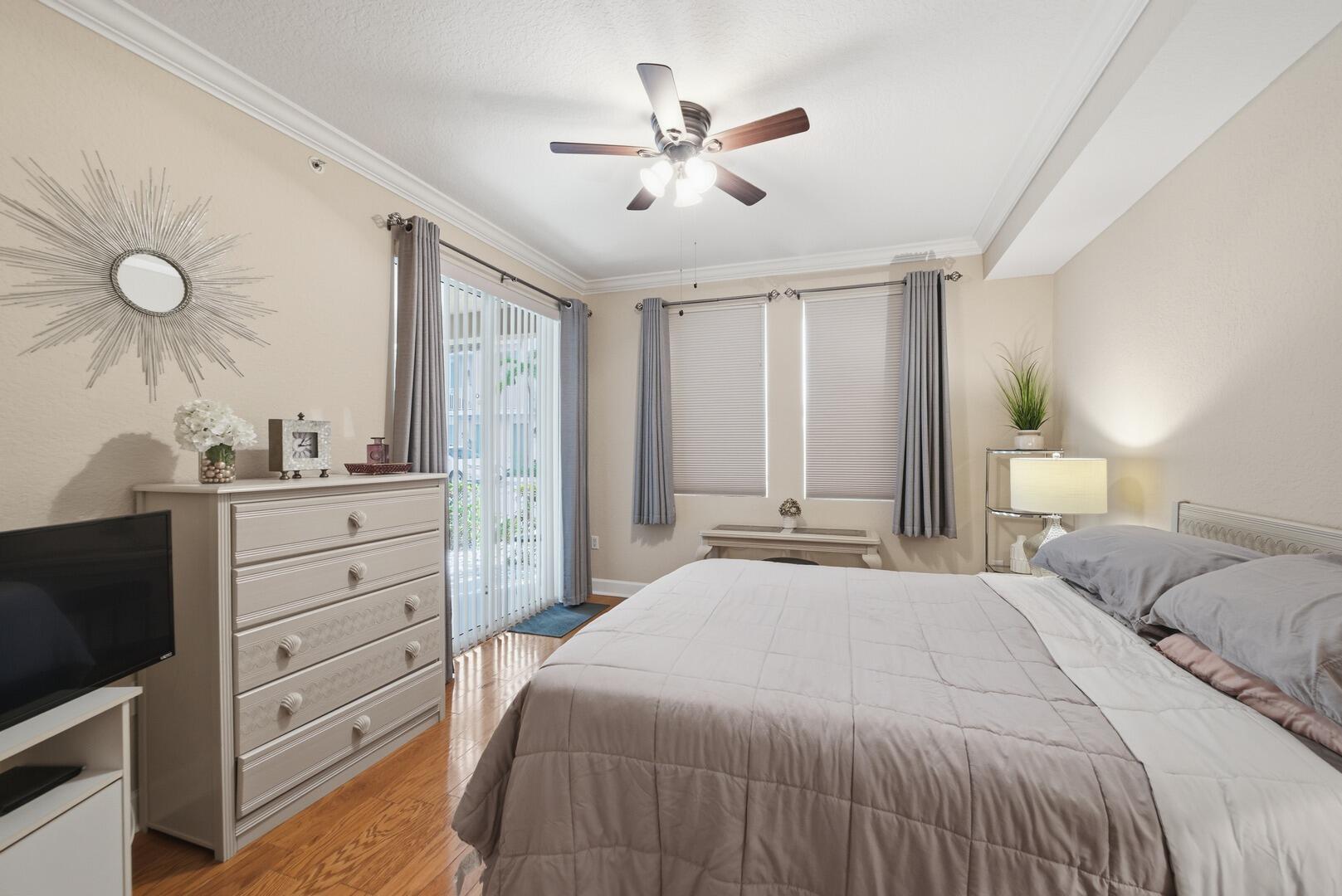 4 Renaissance Way, Unit 110 Boynton Beach, FL 33426 - Photo 15 of 23 a bedroom with a bed and a flat tv screen on dresser