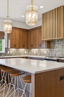 a kitchen with a table chairs sink and cabinets